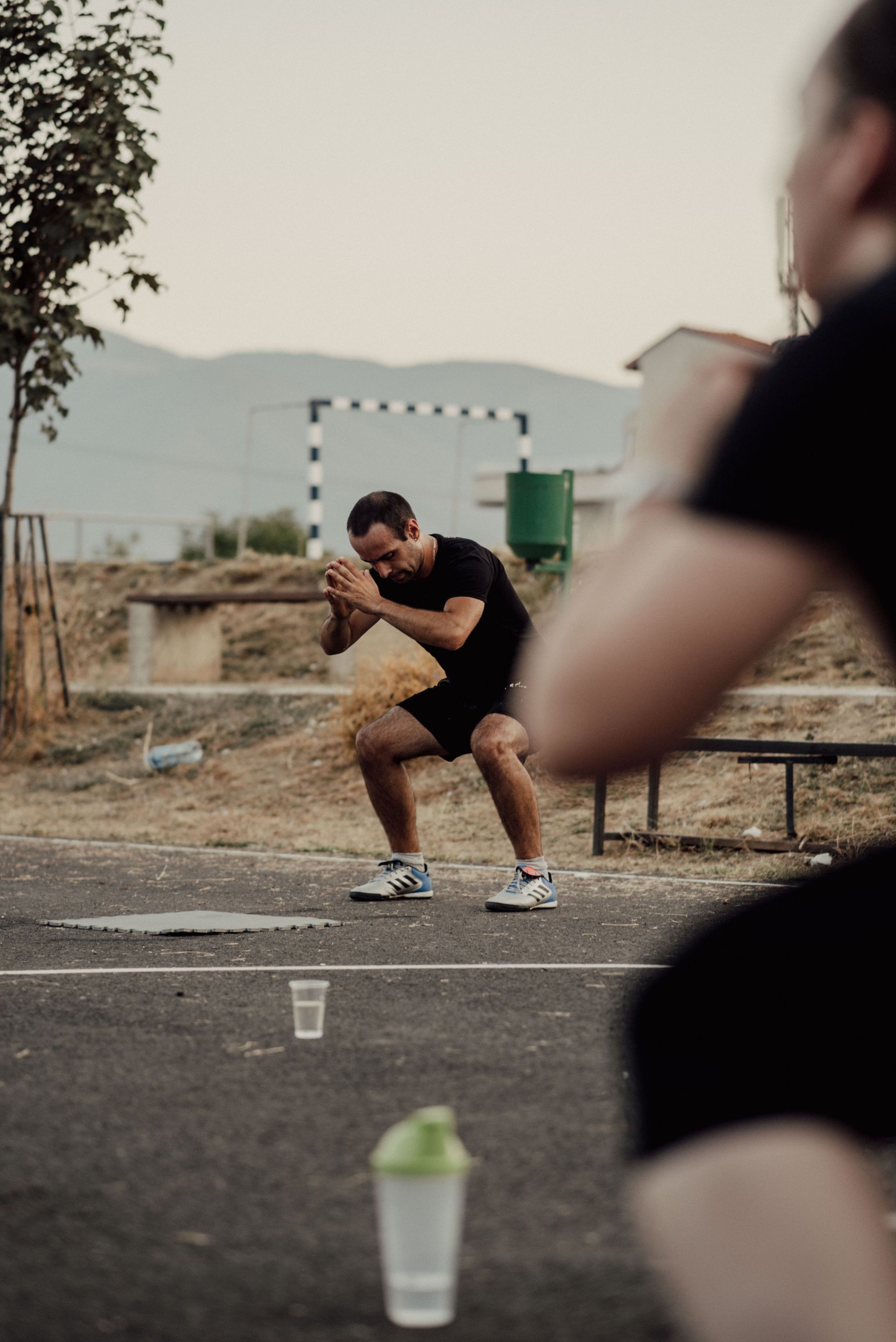 Adults engaging in outdoor fitness activities in a park setting