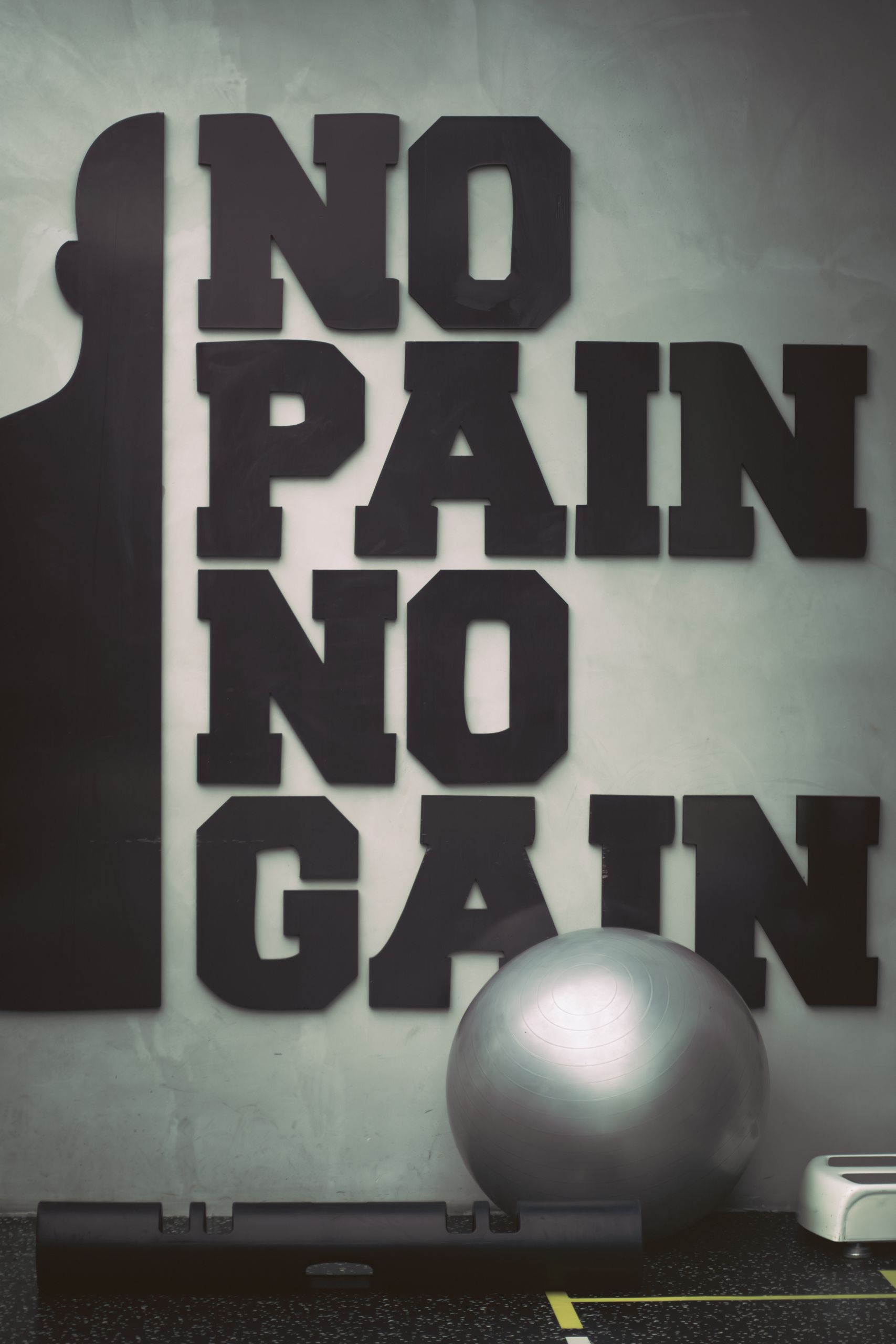 An inspiring gym setting featuring motivational wall art and training equipment