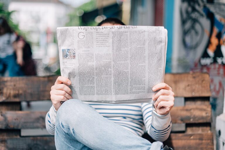 Person holding and reading a newspaper