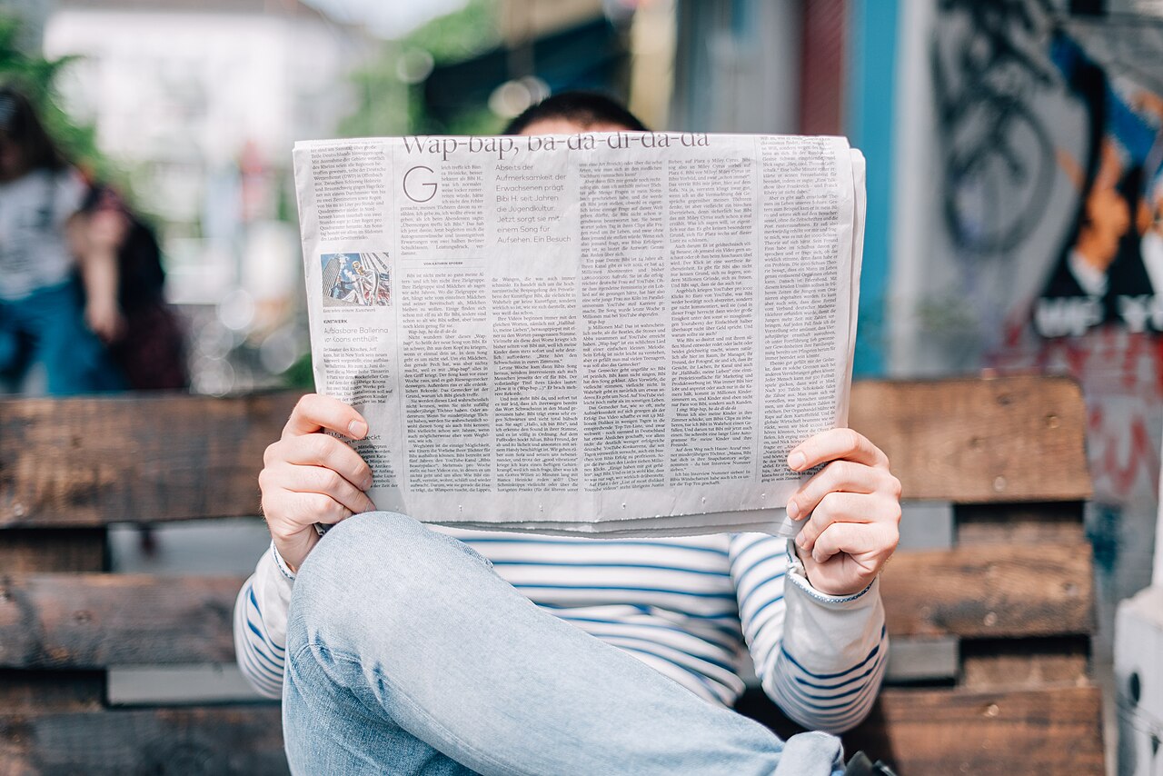 Person holding and reading a newspaper